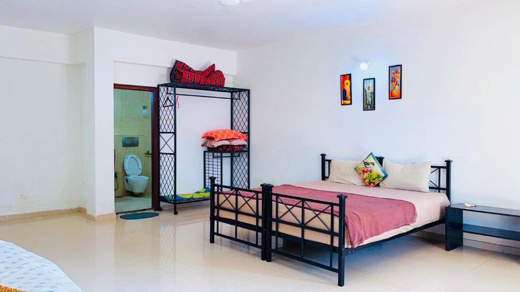 a bedroom with a bed and a mirror at 3bhk Villa calangute in Calangute