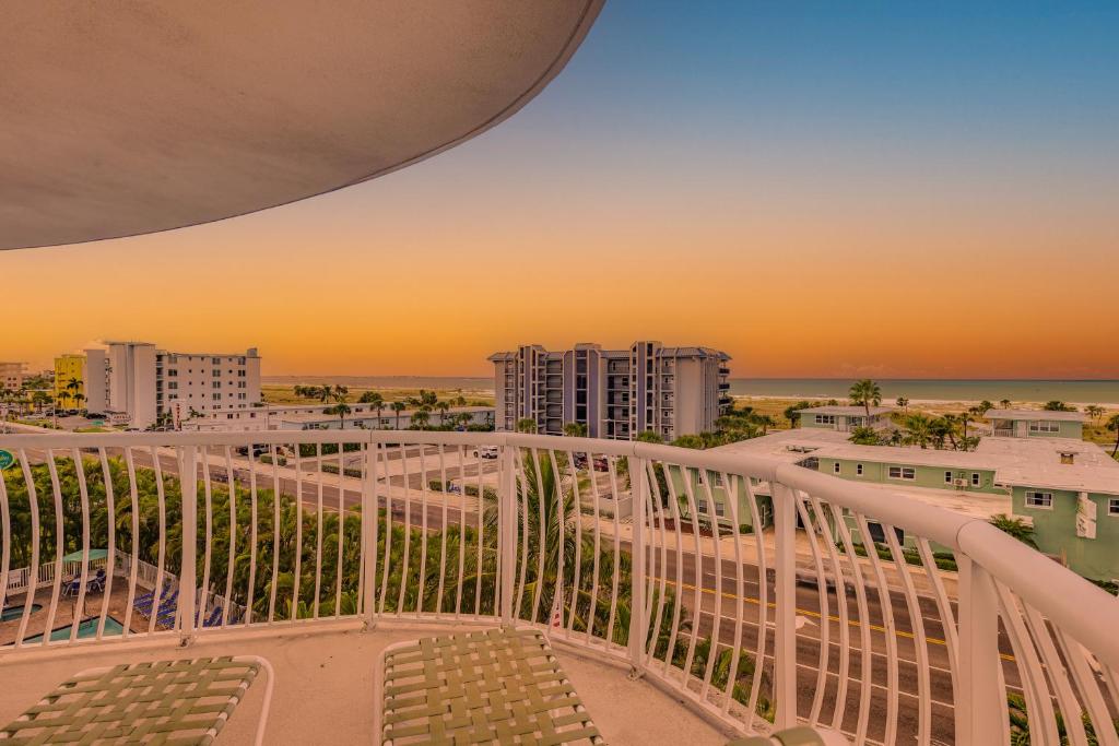a view from the balcony of a condo at sunset at August Beach Getaway Specials Book & Save! in St. Pete Beach