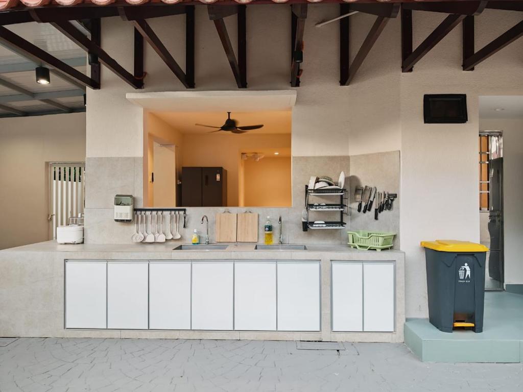 a large kitchen with white cabinets and a ceiling at Mutiara Gurney at 15, Lorong Kelawai in George Town