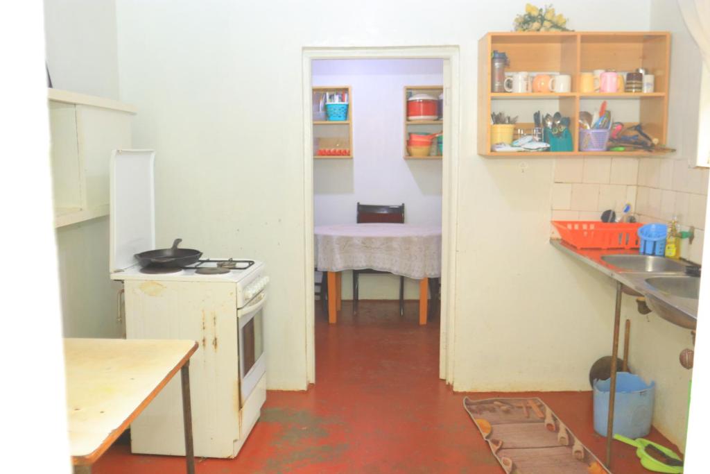 a kitchen with a sink and a table in it at Nancy's Farm House in Chuka