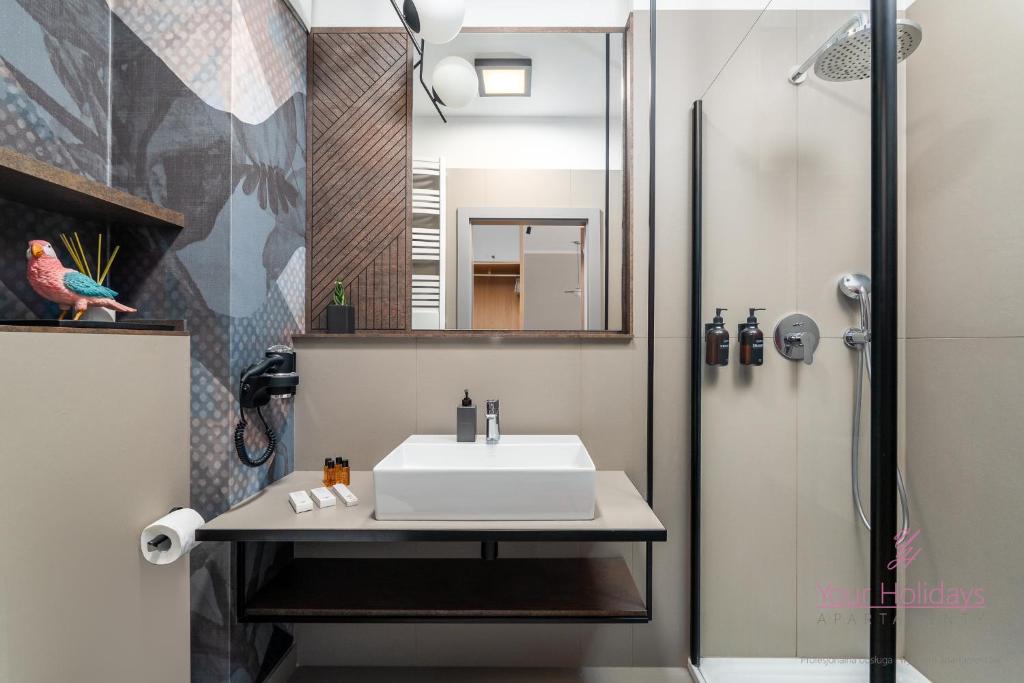 a bathroom with a sink and a shower at Your Holidays Bel Mare Aqua E504 in Międzyzdroje