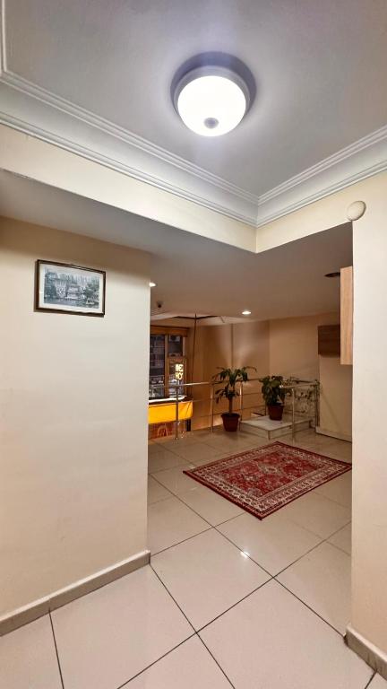 a living room with a white wall and a rug at Efendi Hotel old town special category in Istanbul