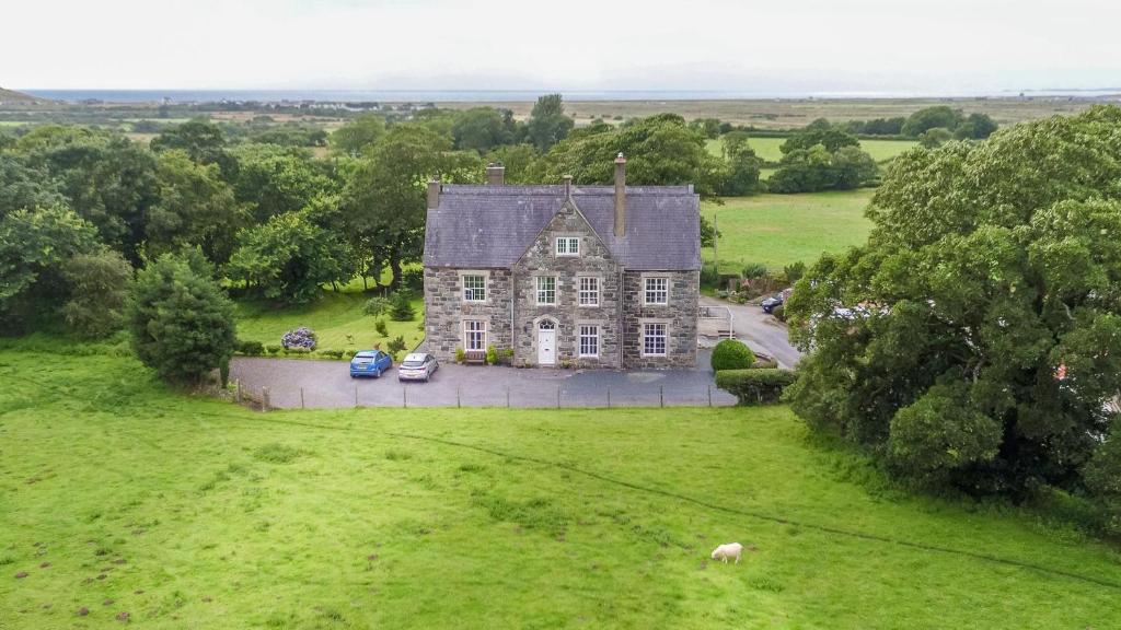 an aerial view of an old house in a field at Ficerdy in Llanwnda