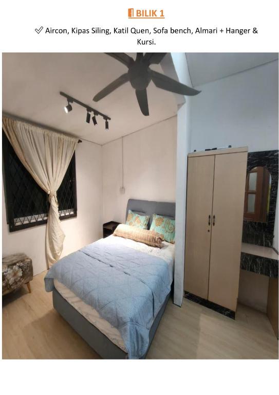 a bedroom with a bed and a ceiling fan at Halwa Homestay in Semporna
