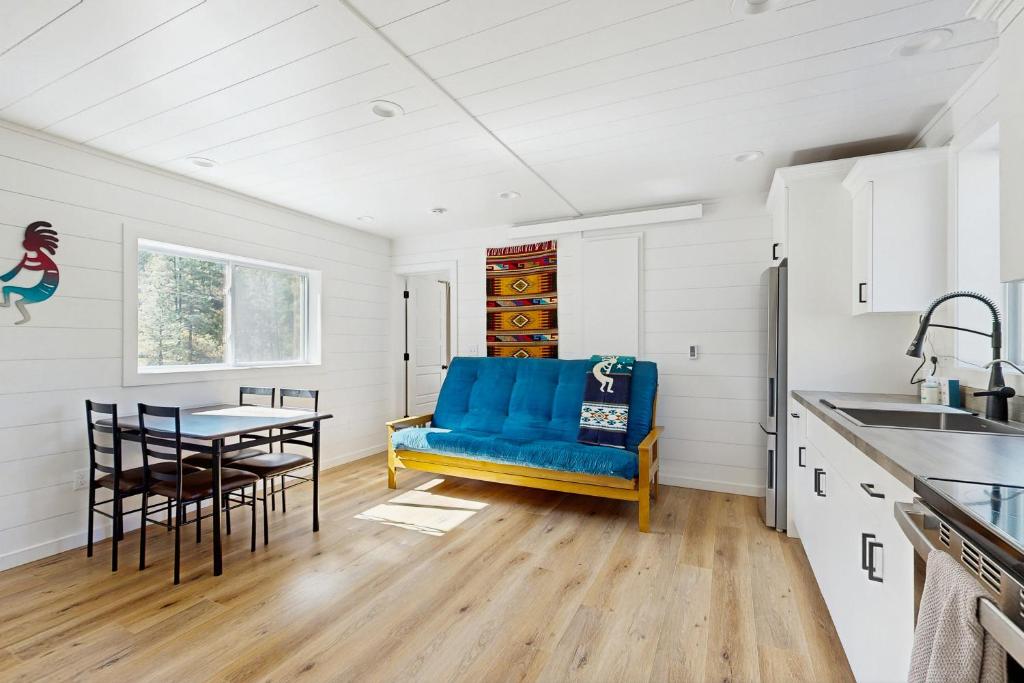 a kitchen with a blue couch and a table at Trails & Tranquility in Pagosa Springs