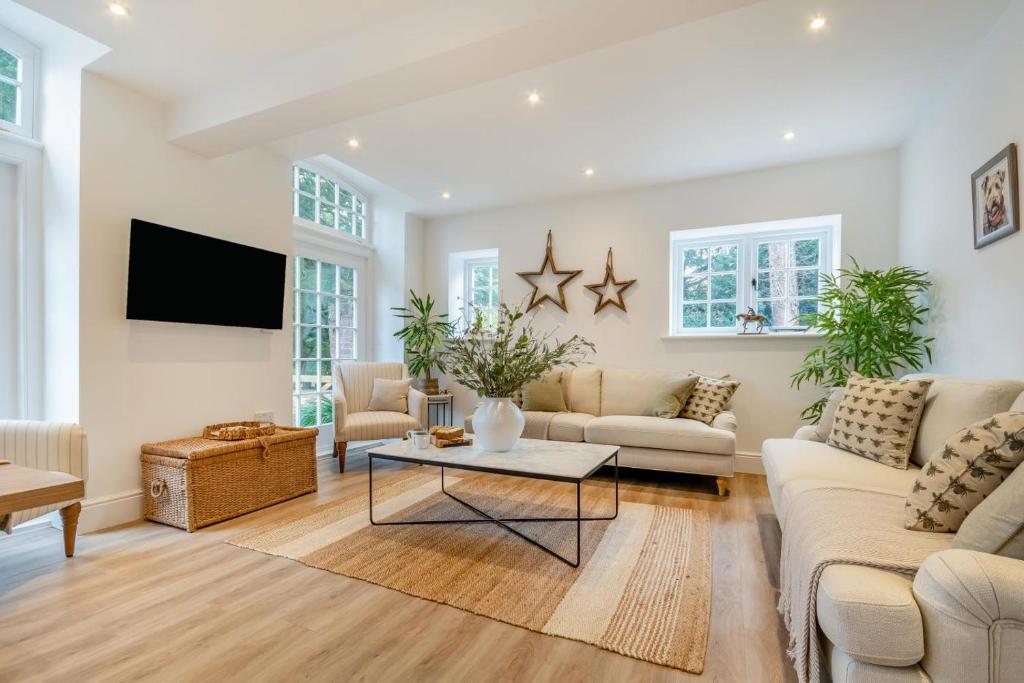a living room with white furniture and a flat screen tv at 3 Bed in Upper Sapey oc-s33623 in Upper Sapey