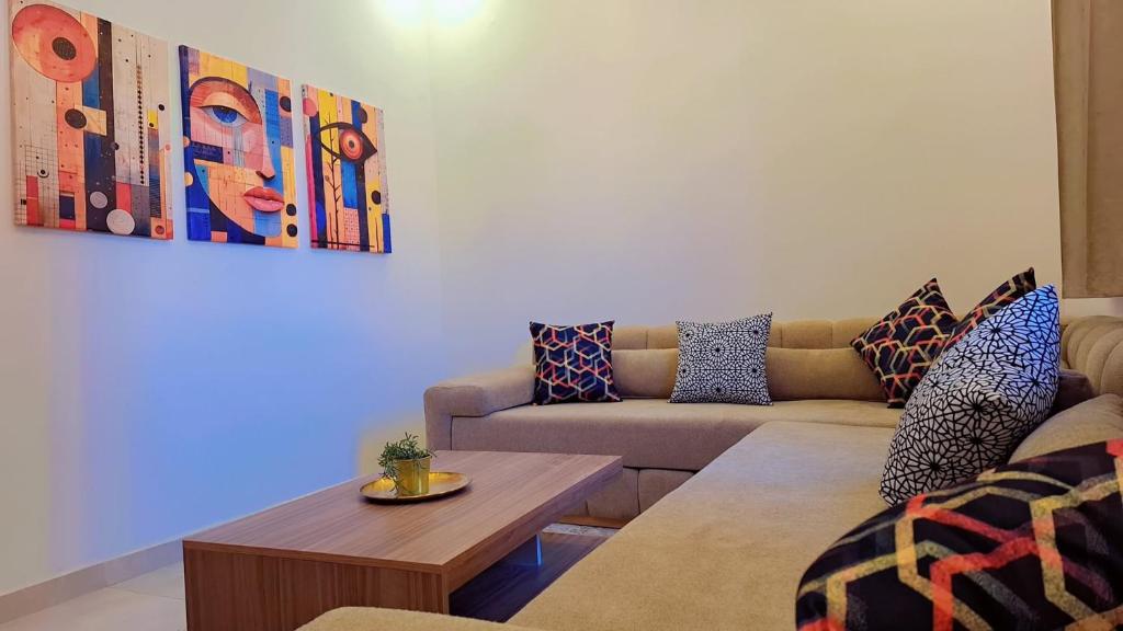 a living room with a couch and a table at Appartement Aéroport Sunset Marrakech in Marrakesh
