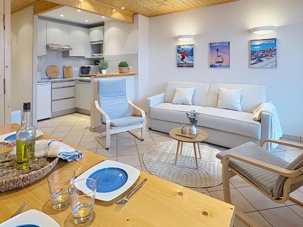 a living room with a couch and a table at Cocon moderne vue pistes - Balcon sud- télécabine 160 m in Chamrousse