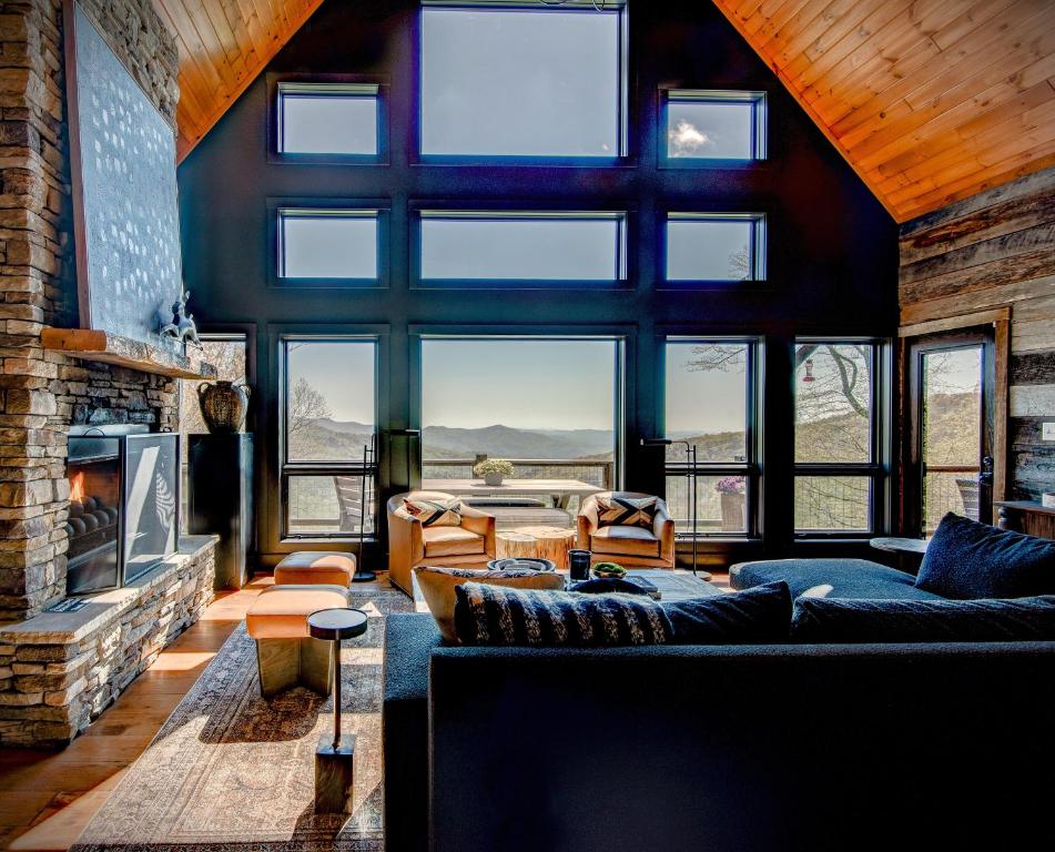 a living room with a couch and a fireplace at Owls Nest in Seven Devils