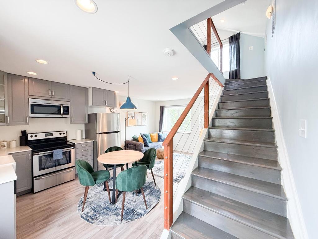 a kitchen and dining room with a staircase and a table at Charming B&B Mezzanine with Free Parking! in Washington