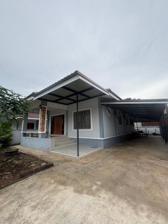 a building with a large garage with a roof at Ban Mae Ku 