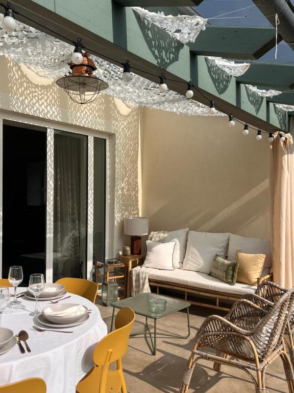 a living room with a couch and tables and chairs at La Casuca del Olivo - casa con jardín cerca de Cabárceno y Santander in Ceceñas