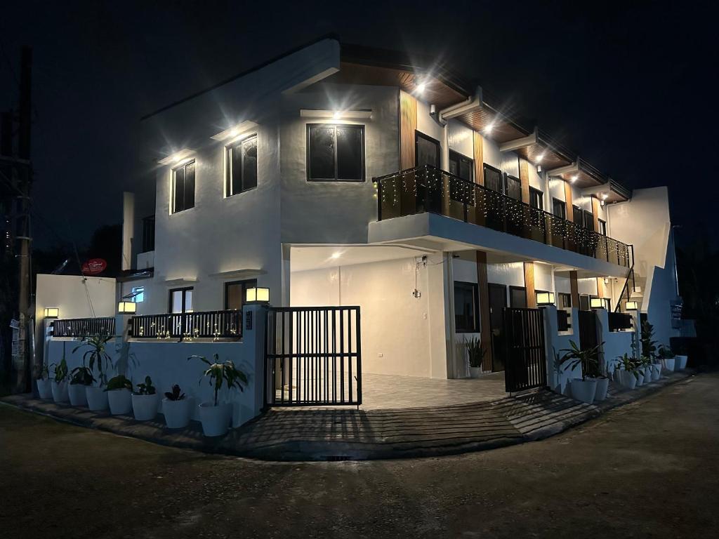 a white building with lights on it at night at Casa Leveria Unit 6 with Balcony, Inquire Parking Availability in Imus