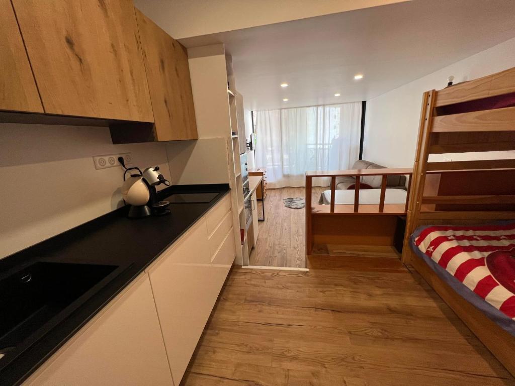 a kitchen with a counter and a bunk bed at Isola 2000 - Front neige Galerie marchande in Isola 2000