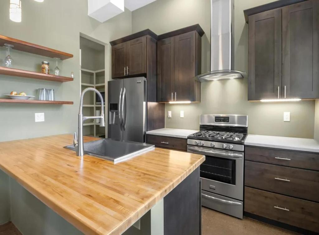 a kitchen with stainless steel appliances and wooden cabinets at Modern Mountain Retreat Single Level Living in Glenwood Springs