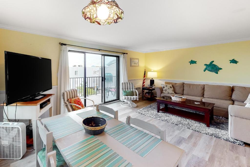 a living room with a couch and a flat screen tv at Sand Dollar II 303 in Ocean City