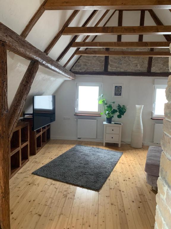 a large living room with wooden floors and exposed beams at Auszeit Deluxe in Kirchheim unter Teck