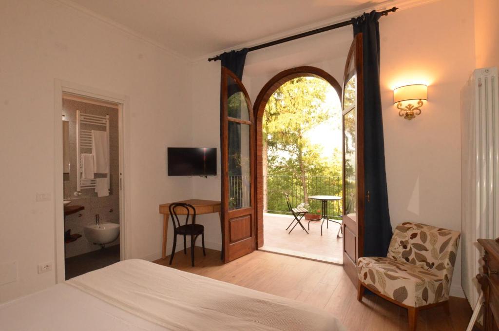a bedroom with a bed and a sliding glass door at Volpicelli B&B in Civitella Alfedena