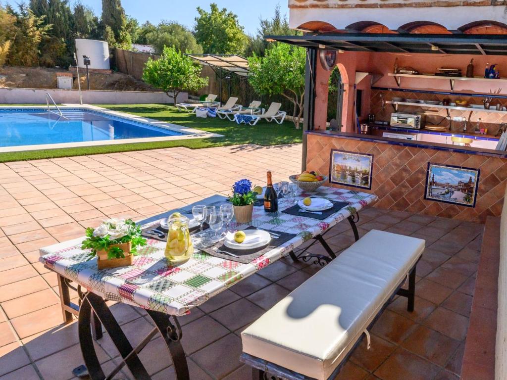 a patio with a table and a swimming pool at casacarmo in Carmona