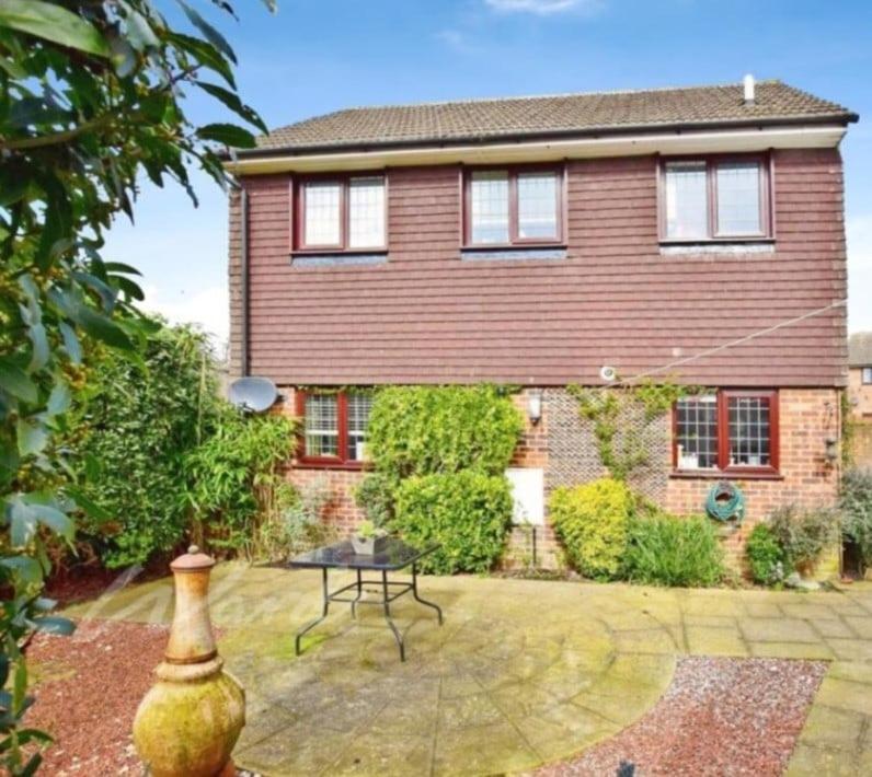 a large brick house with a table in front of it at The welcoming home in Saint Michaels