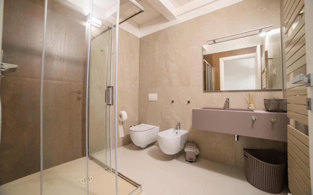 a bathroom with a shower and a toilet and a sink at RESIDENCE OLD STORIES in Barile
