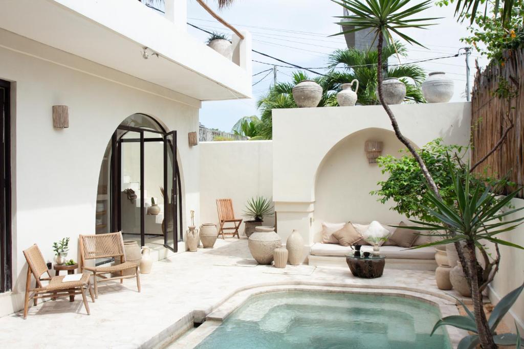 a courtyard with a swimming pool in a house at Villa Bella - Stylish 3-Bedroom Oasis with Mediterranean Charm in Canggu