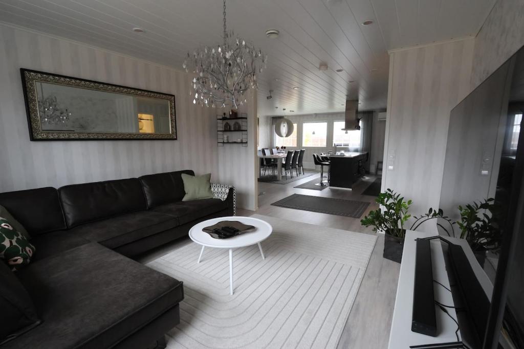 a living room with a couch and a table at Luxury Apartment in the Heart of Pello in Pello