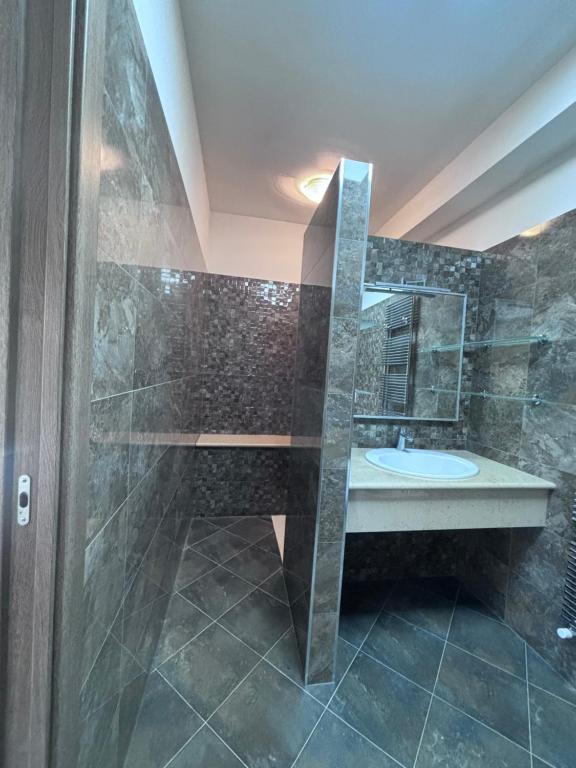 a bathroom with a sink and a shower with a mirror at Casa vacanza fenice in Peschici