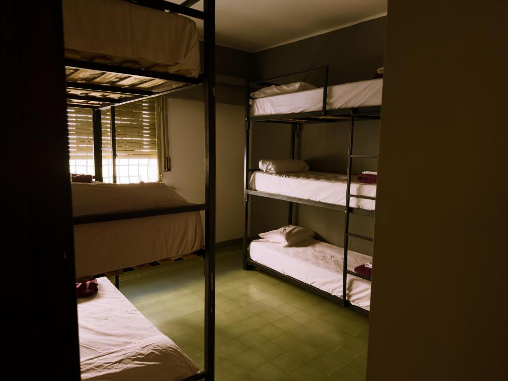 a room with four bunk beds and a window at Lacandona Hostel in Córdoba