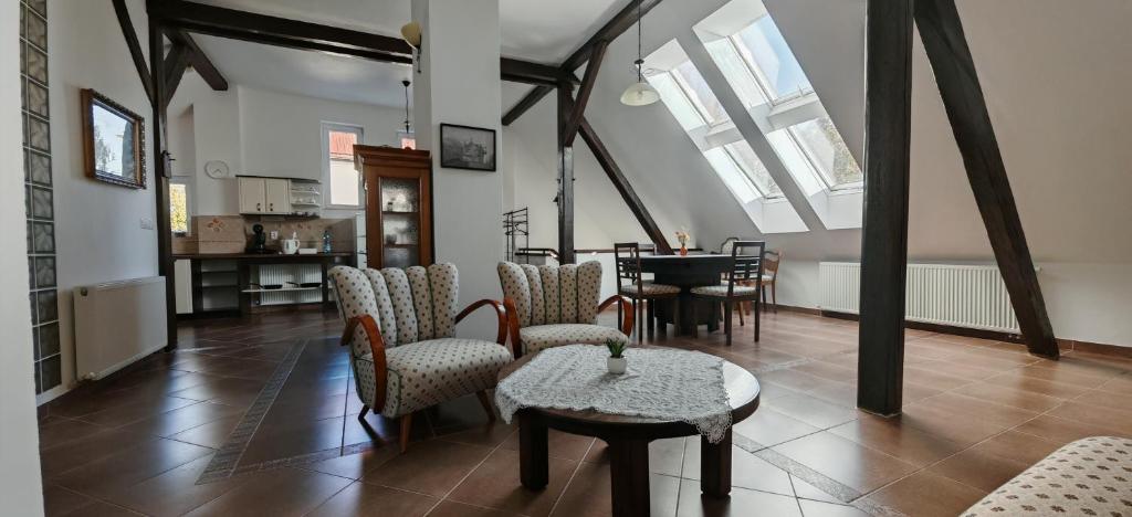 a room with chairs and a table and a dining room at Apartmán Coralina in Zvolen