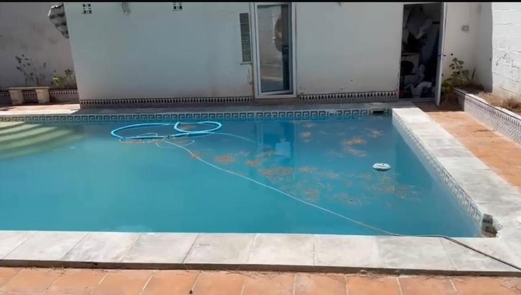a swimming pool with blue water and a basketball at Mar de Luz Boutique in Novo Sancti Petri