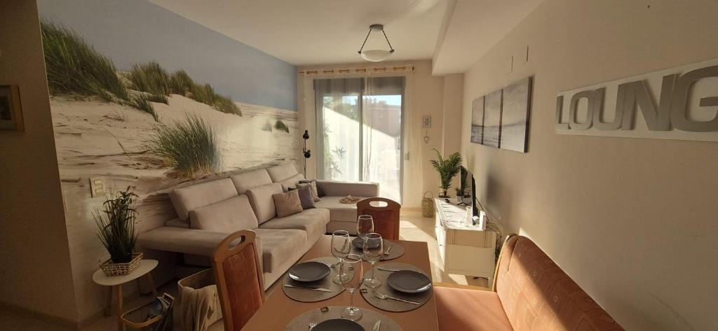 a living room with a couch and a table at Apartamento Timia OASIS in Canet de Berenguer
