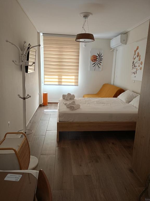 a bedroom with a bed and a window at Votsala in Loutraki