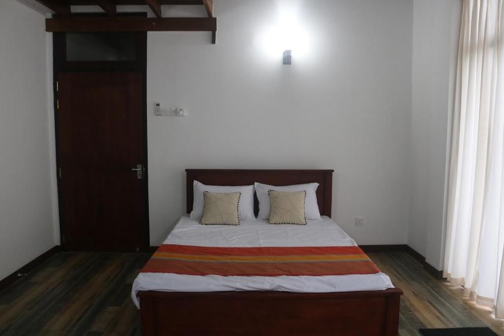 a bedroom with a large bed with two pillows at Eldorado Apartments 3BR Apart No F2P3 in Alwis Town