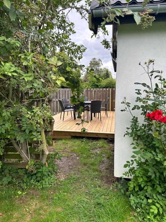 a wooden deck with a table and chairs on it at AWCompany Aps WORK & STAY-North Zealand Crew Accommodation in Tisvildeleje