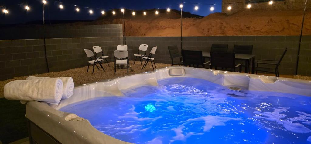 a jacuzzi tub with a table and chairs in a room at Hot Tub, Kayaks, Game Room, Boat Parking, Fire Pit, King, WD in Page