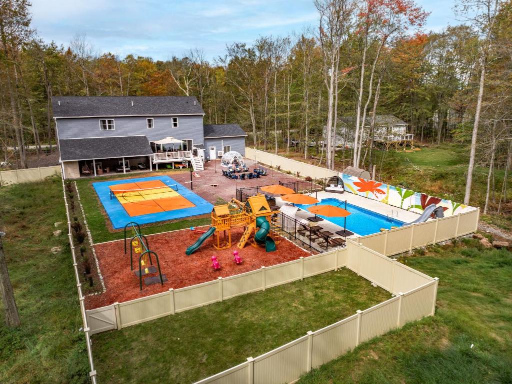 an aerial view of a backyard with a playground at The Poconest - Luxurious Mountain Mansion in Long Pond