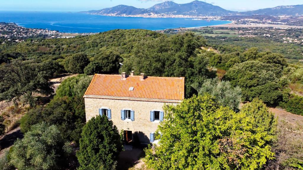 an aerial view of a stone house with a red roof at Maison de maître en pierre de 1831 avec vue sur la mer à Porticcio in Porticcio