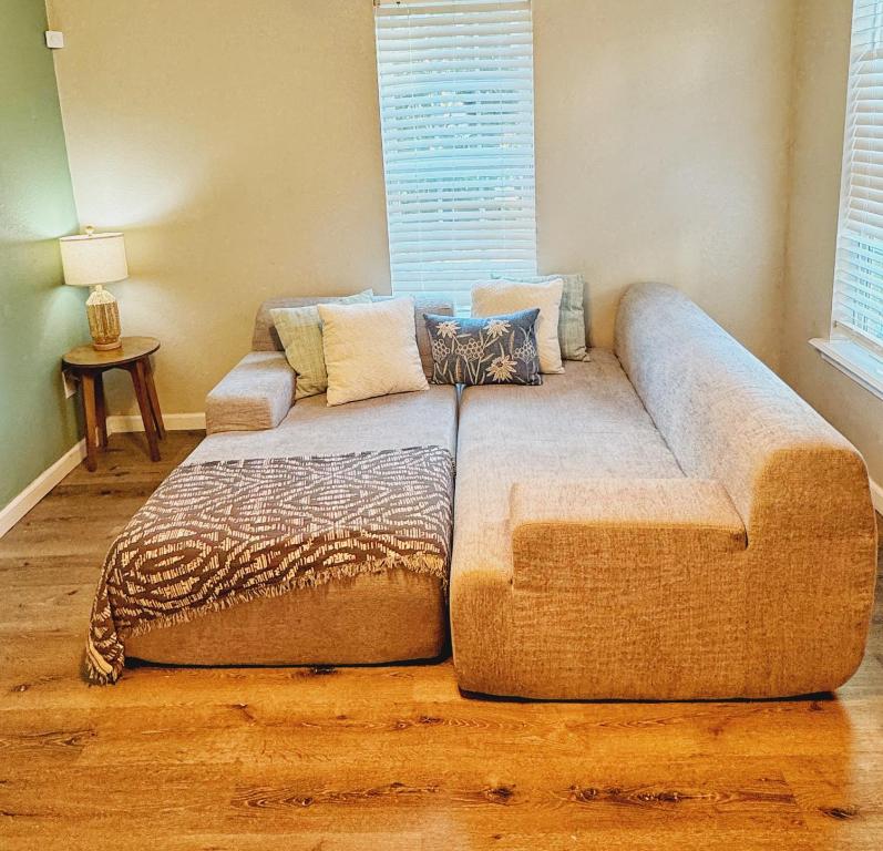 a large couch sitting in a living room at Downtown Fort Smith Apartment with Yard Pet Friendly in Fort Smith