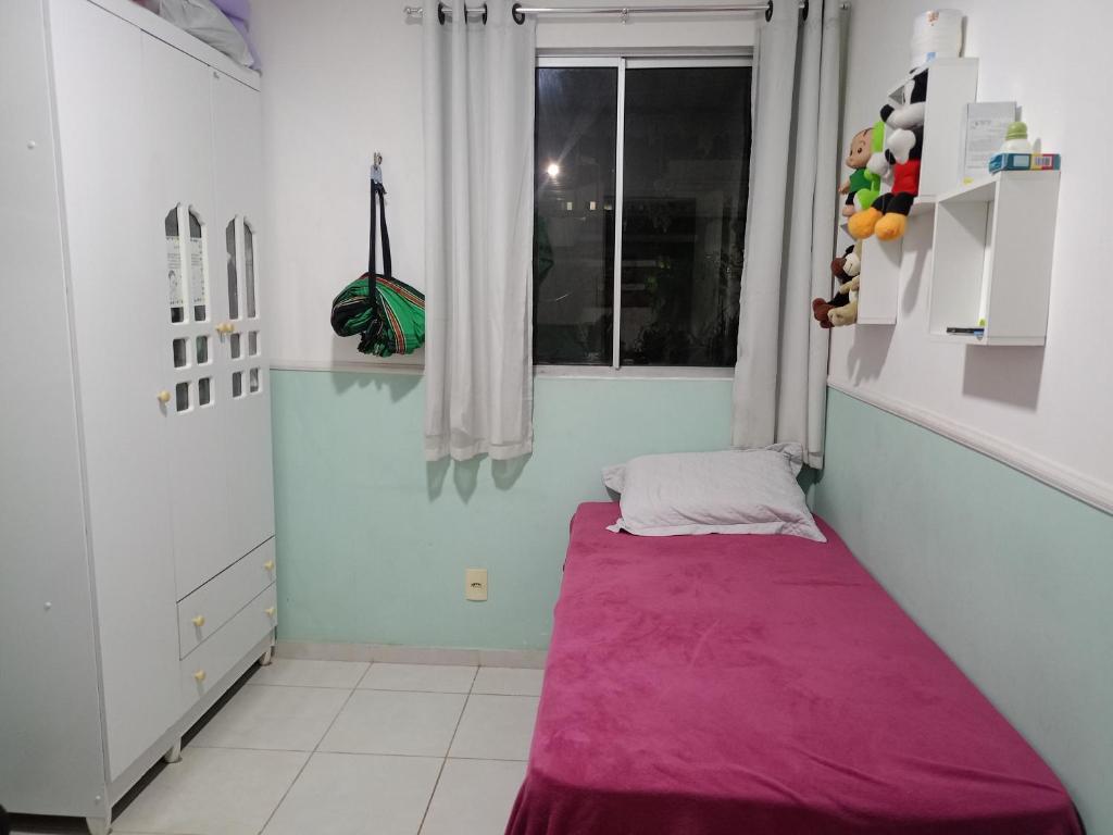 a room with a purple mattress in a room with a window at AP COP 30 com Garagem em Cond in Marituba