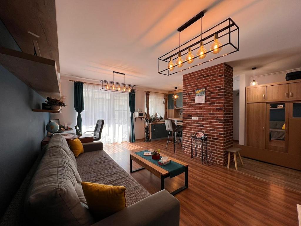 a living room with a couch and a table at Timeless Comfort in Sfântu-Gheorghe