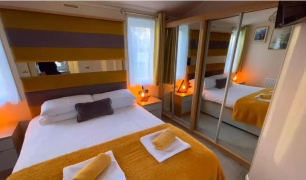 a hotel room with a bed with two towels on it at The View Point Northumberland in Newton on the Moor