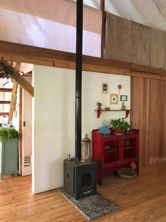 a room with a wood stove in a room at la casa en el rio II in Tigre