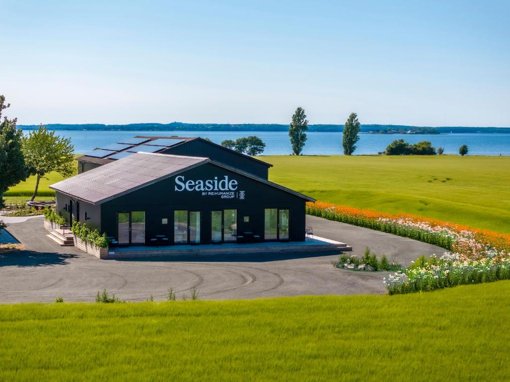 a large building with a sign for a service station at Seaside Retreat & Hotel in Stege