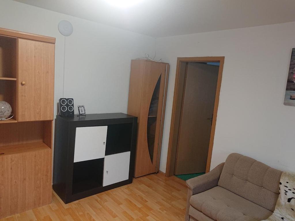 a living room with a couch and a chair at Ferienwohnung Erlangen Urlaub mitten in Franken in Wachenroth