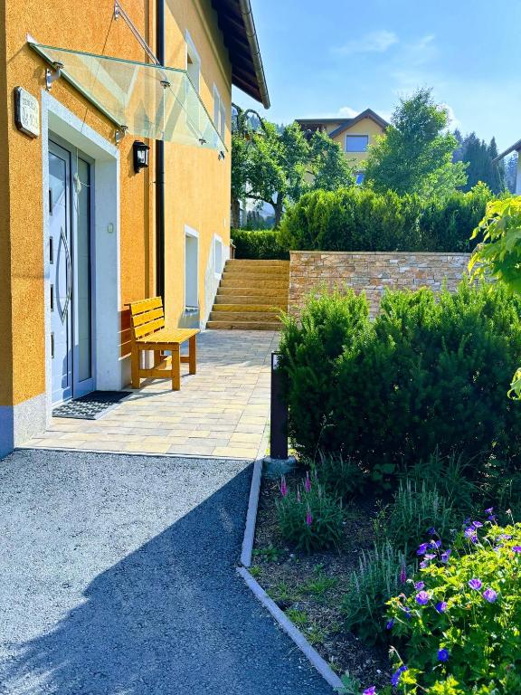 a wooden bench sitting outside of a house at Apartment Warmuth in Tröpolach