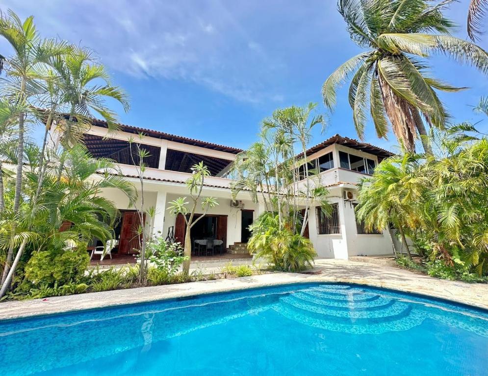 a house with a swimming pool in front of it at Casa Horizonte Ocean view and Carrizalillo access in Puerto Escondido