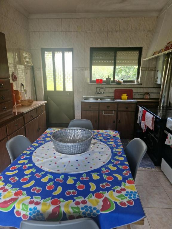 a kitchen with a table with a bowl on it at Casa da Padaria velha in Tourigo