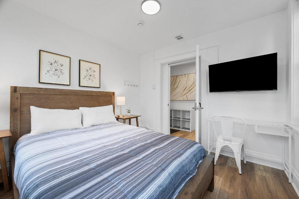 a bedroom with a bed and a flat screen tv at Pittsburgh Shadyside 2A Bright and Stylish Private Bedroom with Shared Bathroom in Pittsburgh