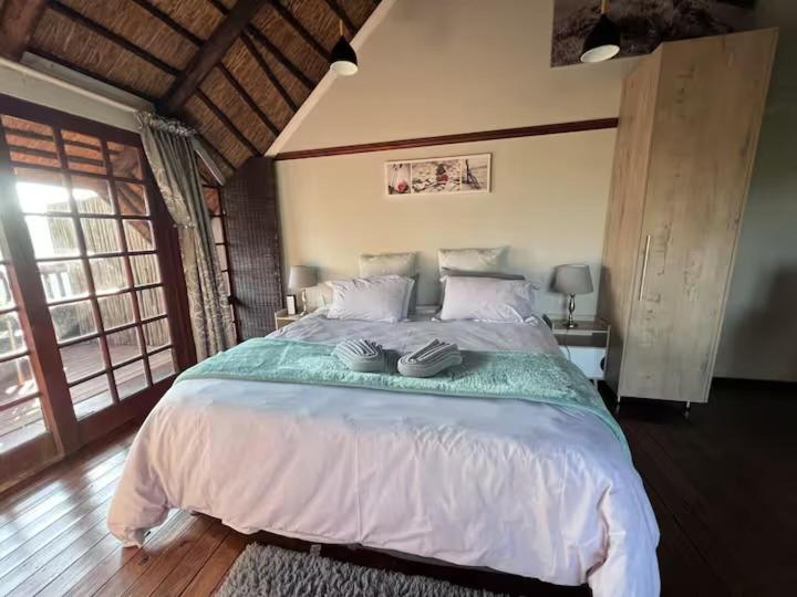 a bedroom with a large bed in a room at Mountain whispers in Hazyview